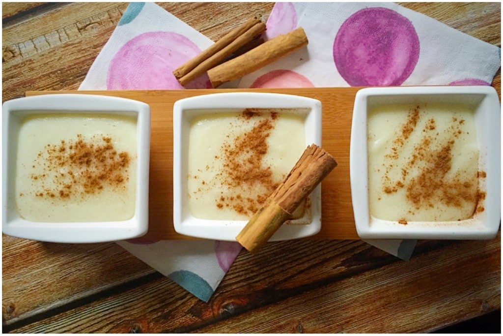 Overhead shoot of 3 small bowls of semolina pudding with ground cinnamon on top