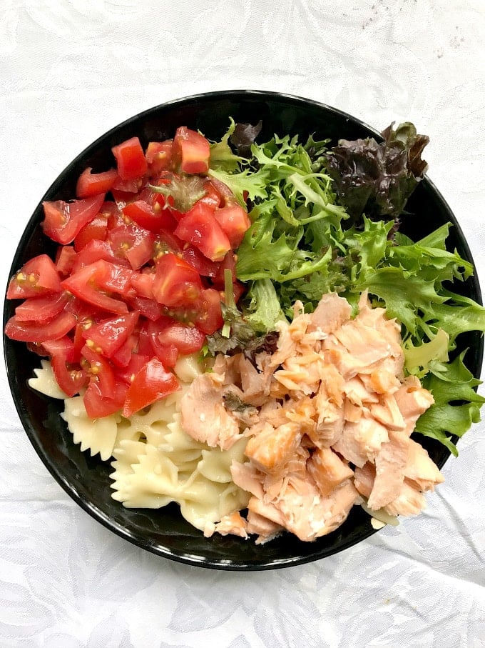 Overhead shoot of a black bowl of pasta salad