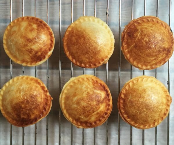 6 mini mushroom pies on a cooling rack