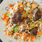 Overhead shot of a plate with pilaf with chicken livers and vegetables