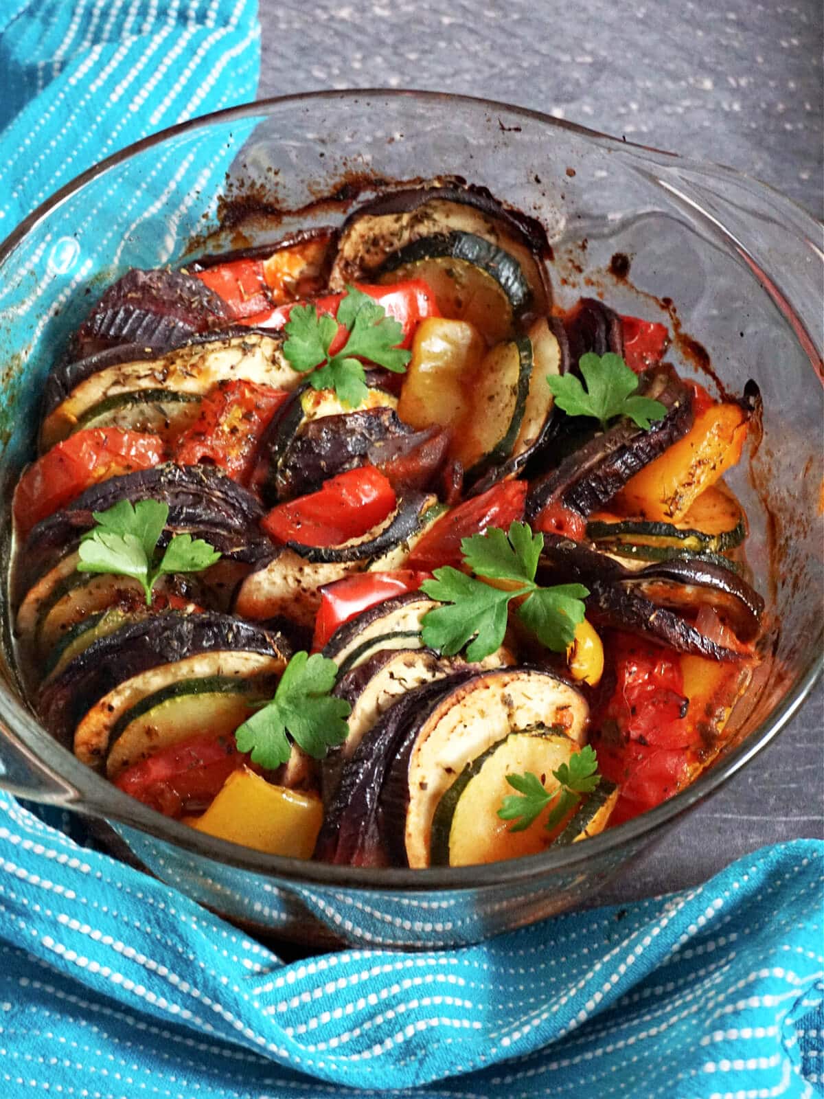 A glass dish with baked ratatouille.