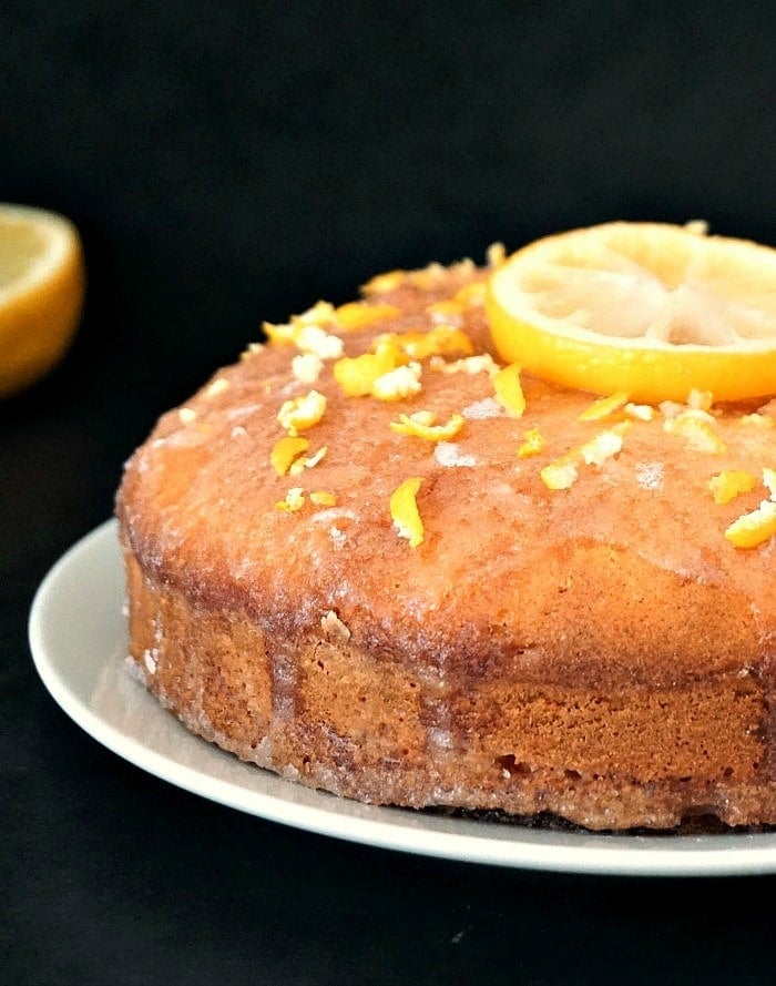 A lemon drizzle cake topped with a slice of lemon