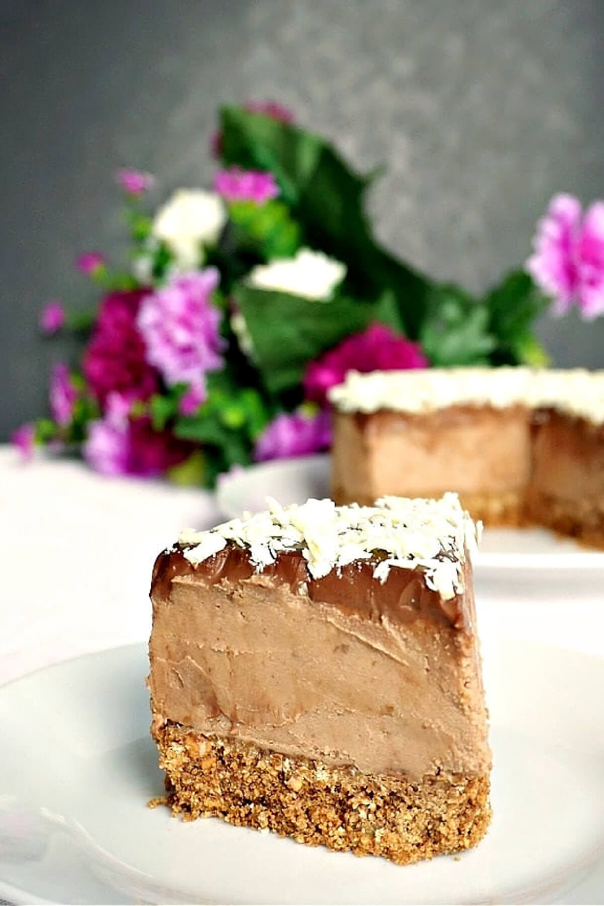 A slice of chocolate cheesecake on a white plate.