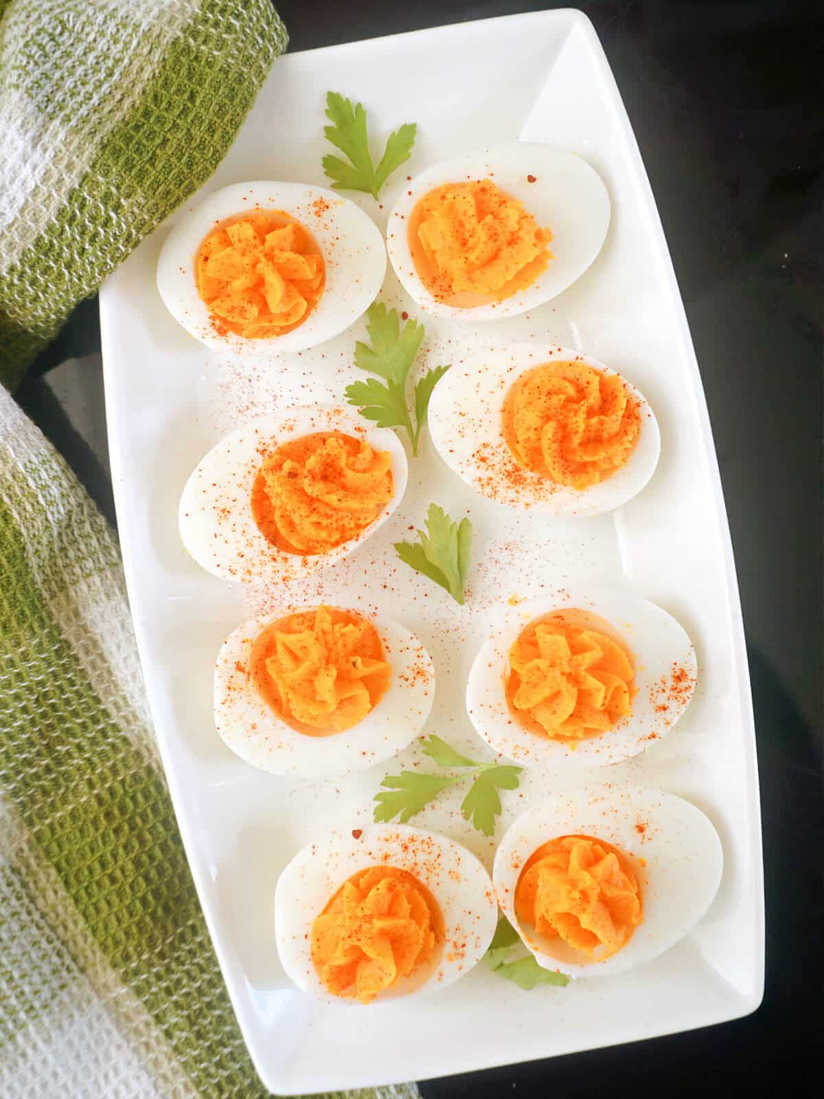 Overhead shoots of a white rectangle plate with 8 deviled eggs