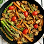 A frying pan with quorn chicken pieces with veggies