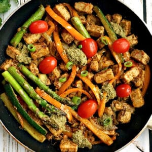 A frying pan with quorn chicken pieces with veggies