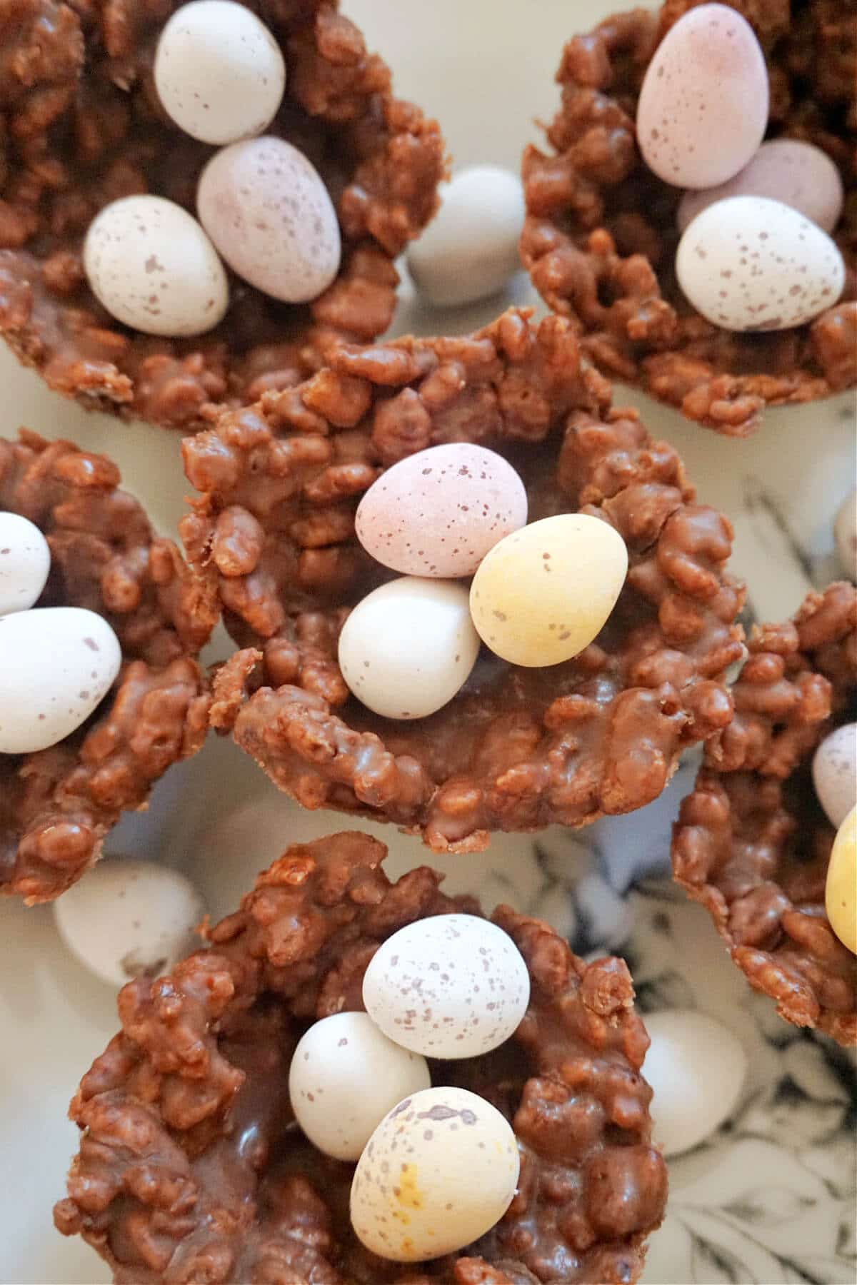 Overheas shot of 6 chocolate rice krispie nests filled with 3 mini chocolate eggs each