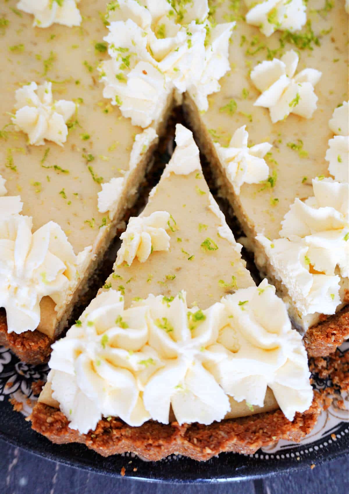 Close-up shot of a slice of key lime pie cut out of the pie.