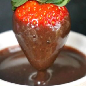 A strawberry dipped in chocolate sauce
