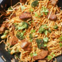 A wok with noodle stir fry with beef and broccoli