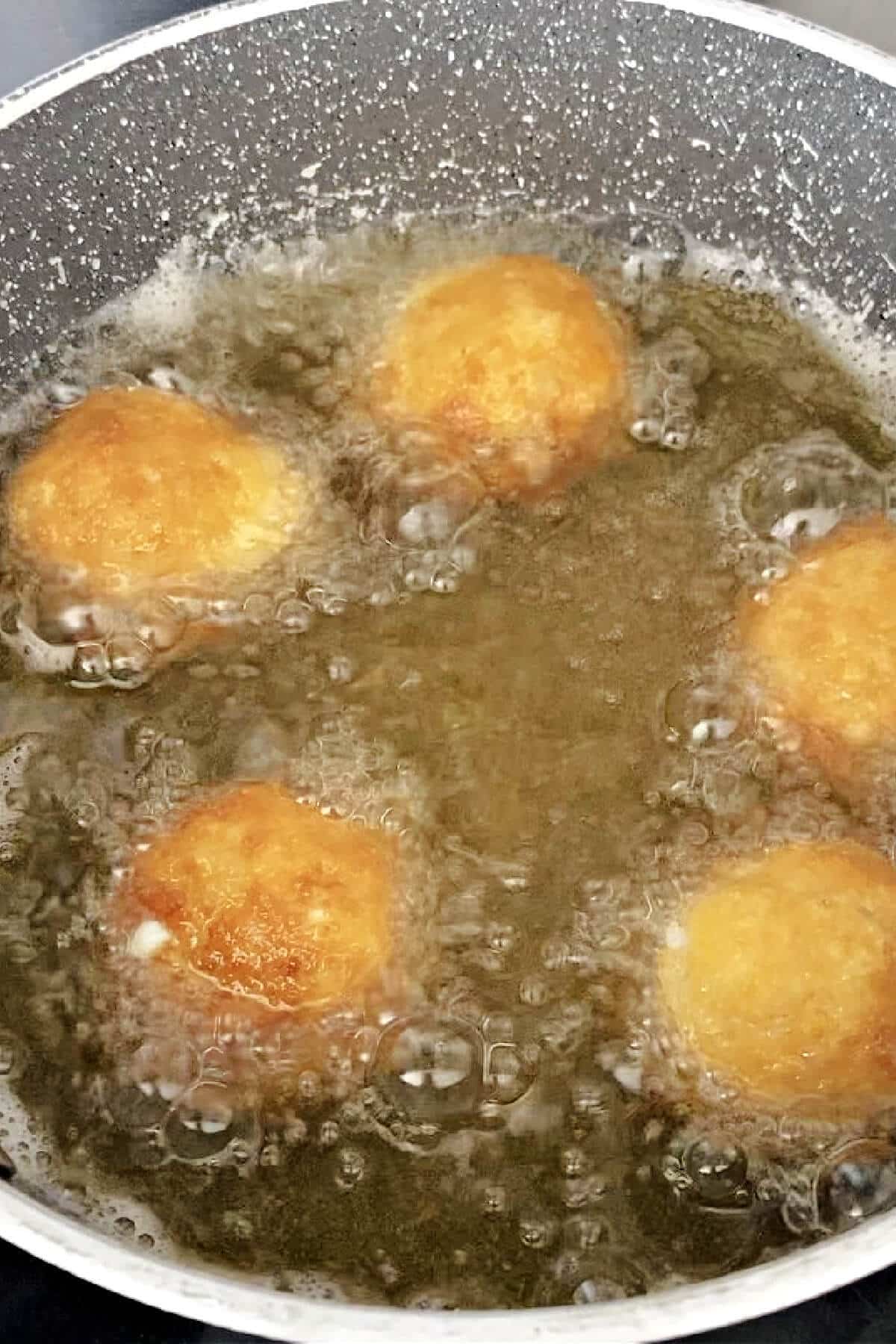 A pan with deep fried arancini.