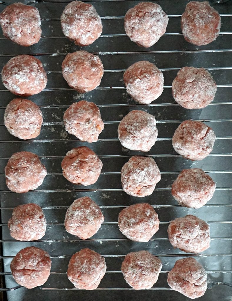 Overhead shoot of raw meatballs to be baked in the oven