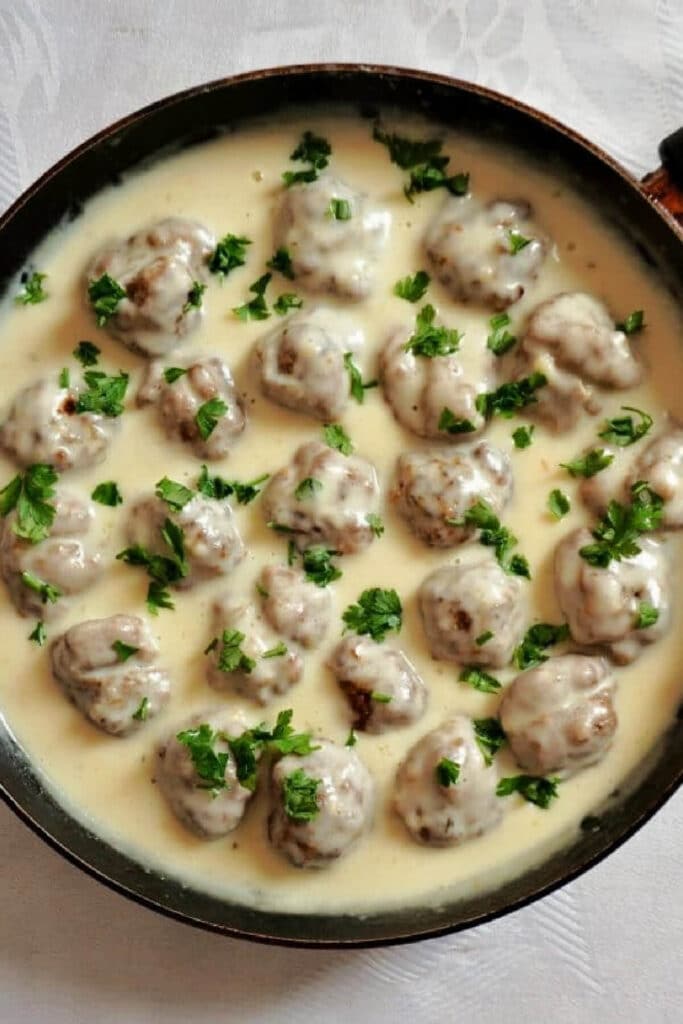 Overhead shoot of a pan with Swedish meatballs in white sauce