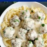 Healthy Swedish Meatballs in a light gravy sauce, served on a bed of fusilli pasta; a complete meal for a family dinner. Satisfying, easy to put together, and really tasty. Comfort food at its best, these baked meatballs rival the popular Ikea meatballs. #bakedmeatballs, #swedishmeatballs, #comfortfood, #gravy, #dinnerrecipe