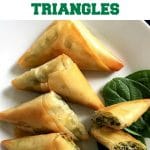 Greek Spanakopita Triangles or feta and spinach pies, a fantastic appetizer or healthy snack and can be enjoyed either warm or cold. Learn how to fold the phyllo dough to perfection and impress all your guests with these fabulous bites.