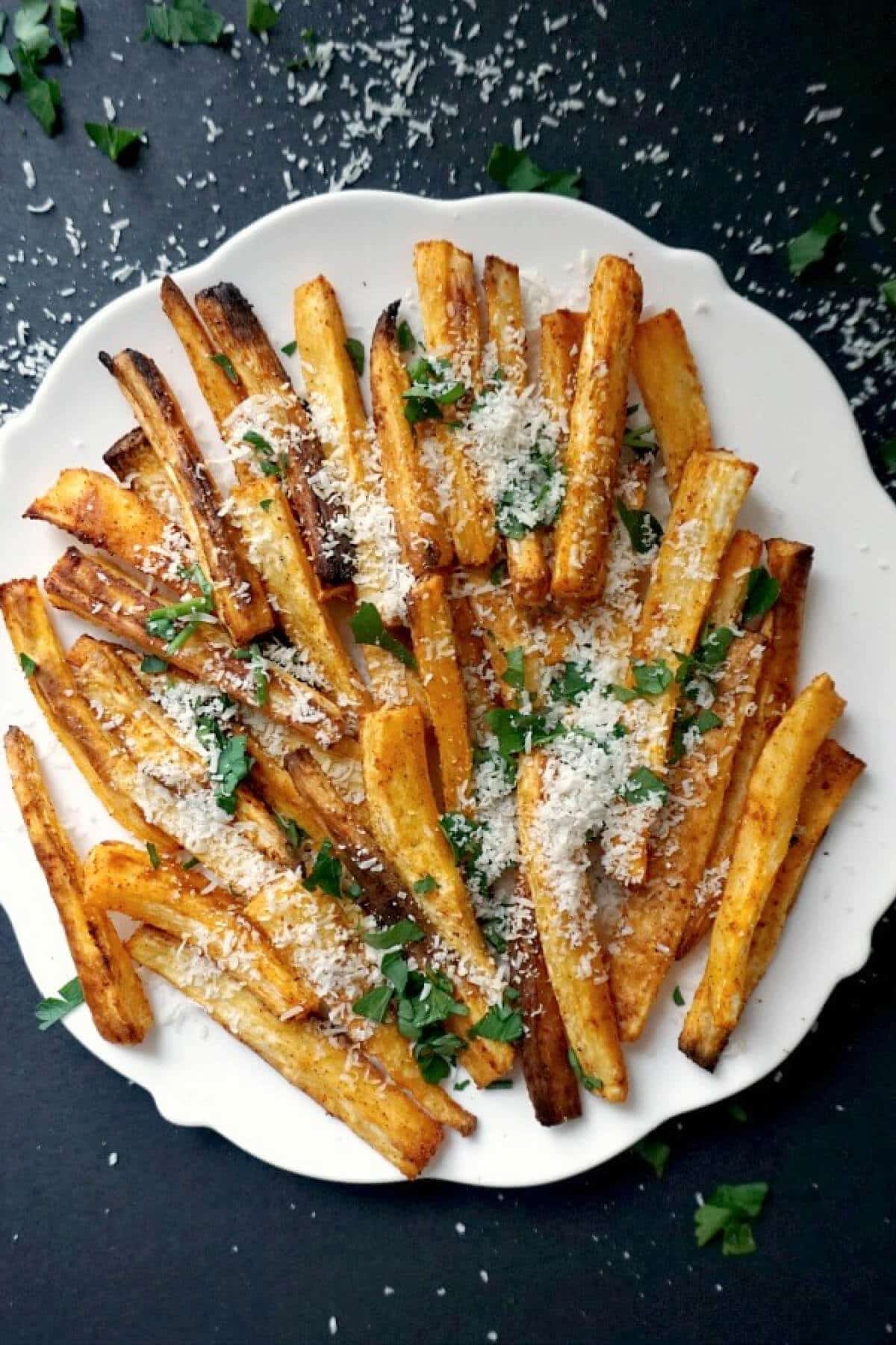 Overhead shoot of a white plate with parsnip chips.