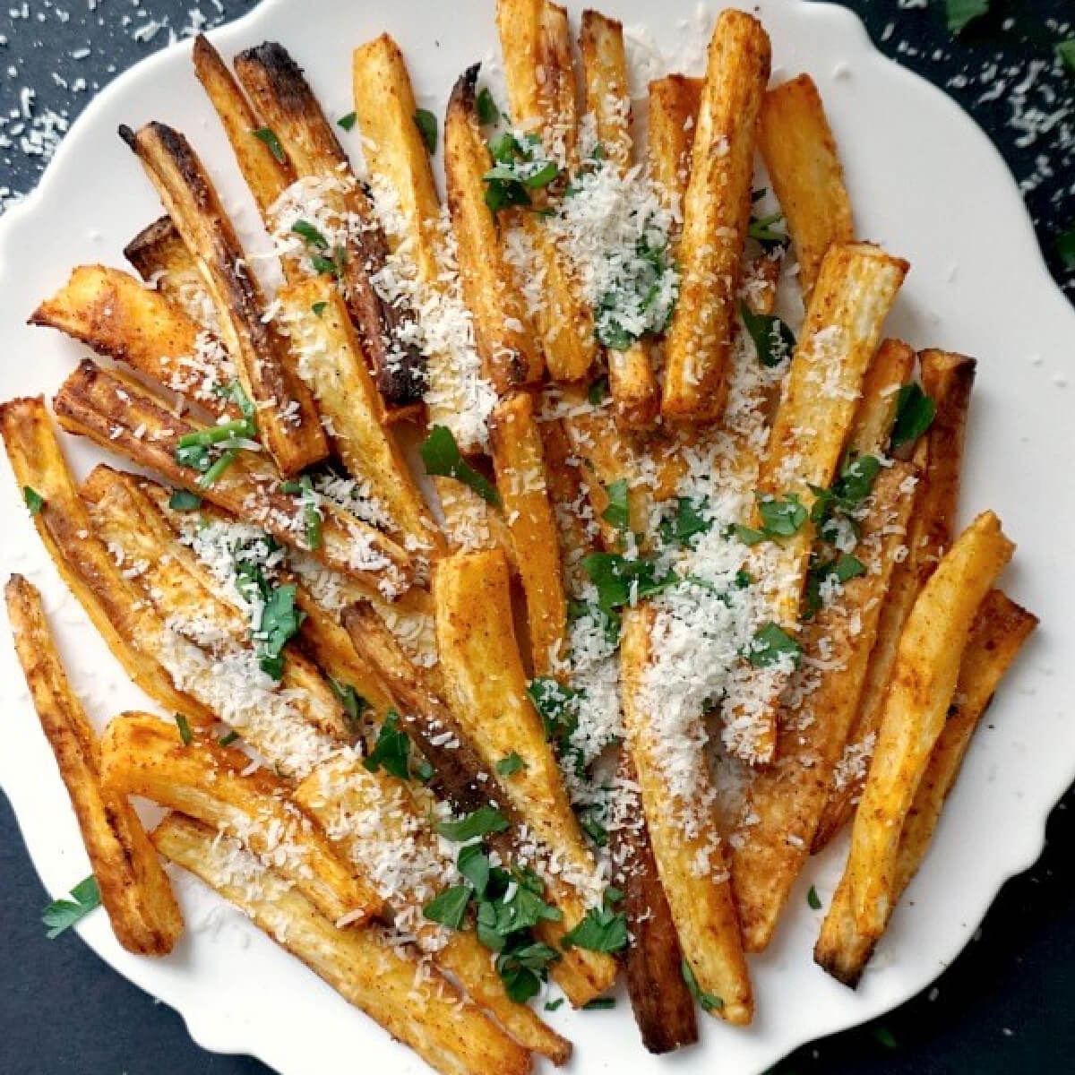 A white plate with parsnip chips