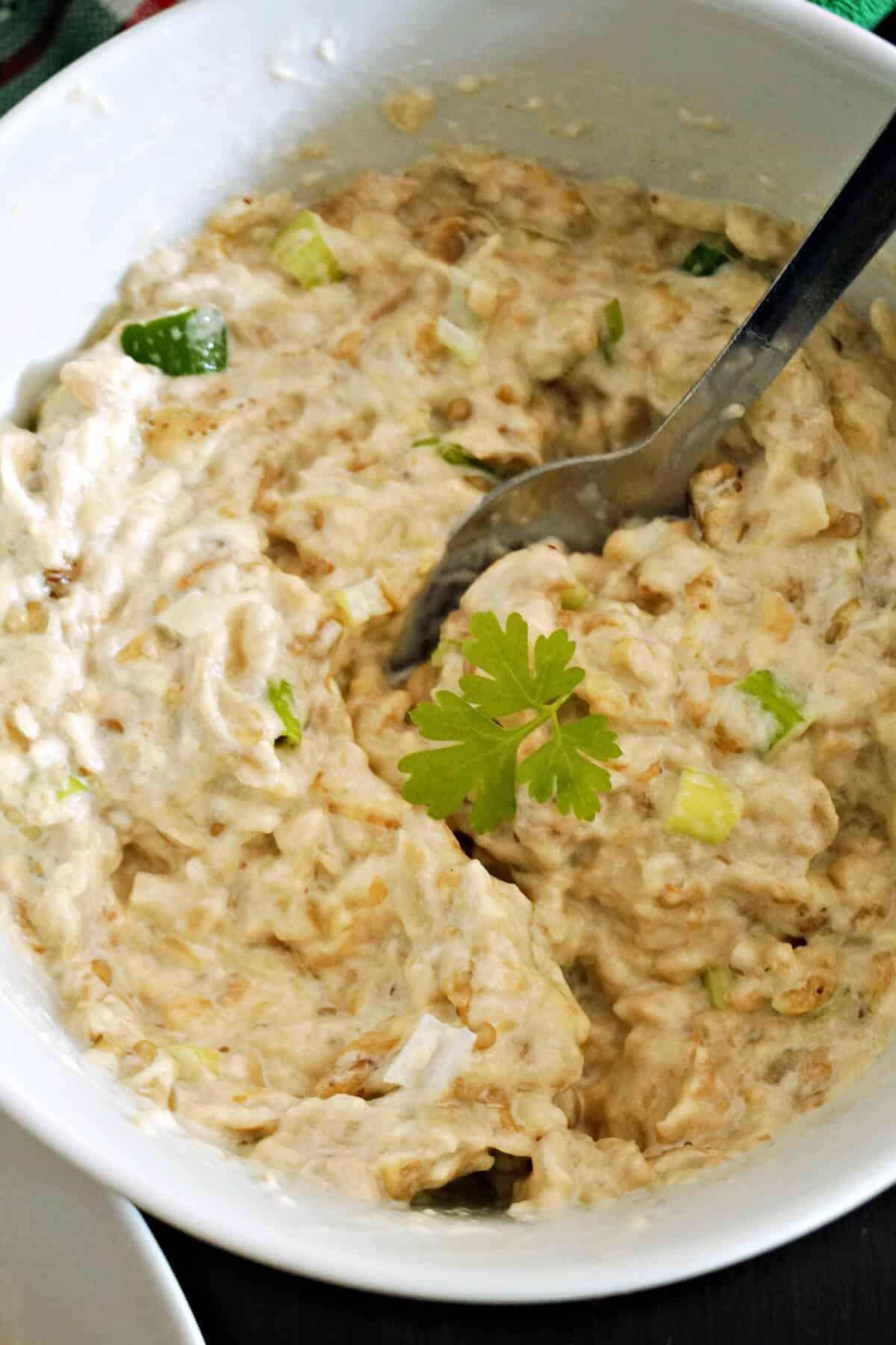 A white bowl with aubergine salad.