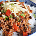 Close-up shoot of a bowl of rice and chili with beans and cheese