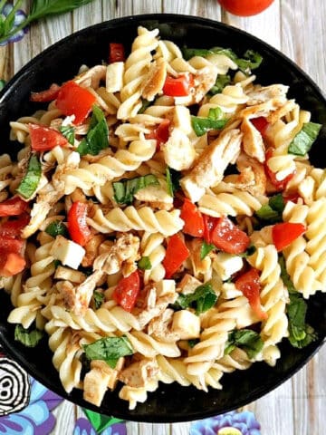 Overhead shoot of a black plate of pasta salad