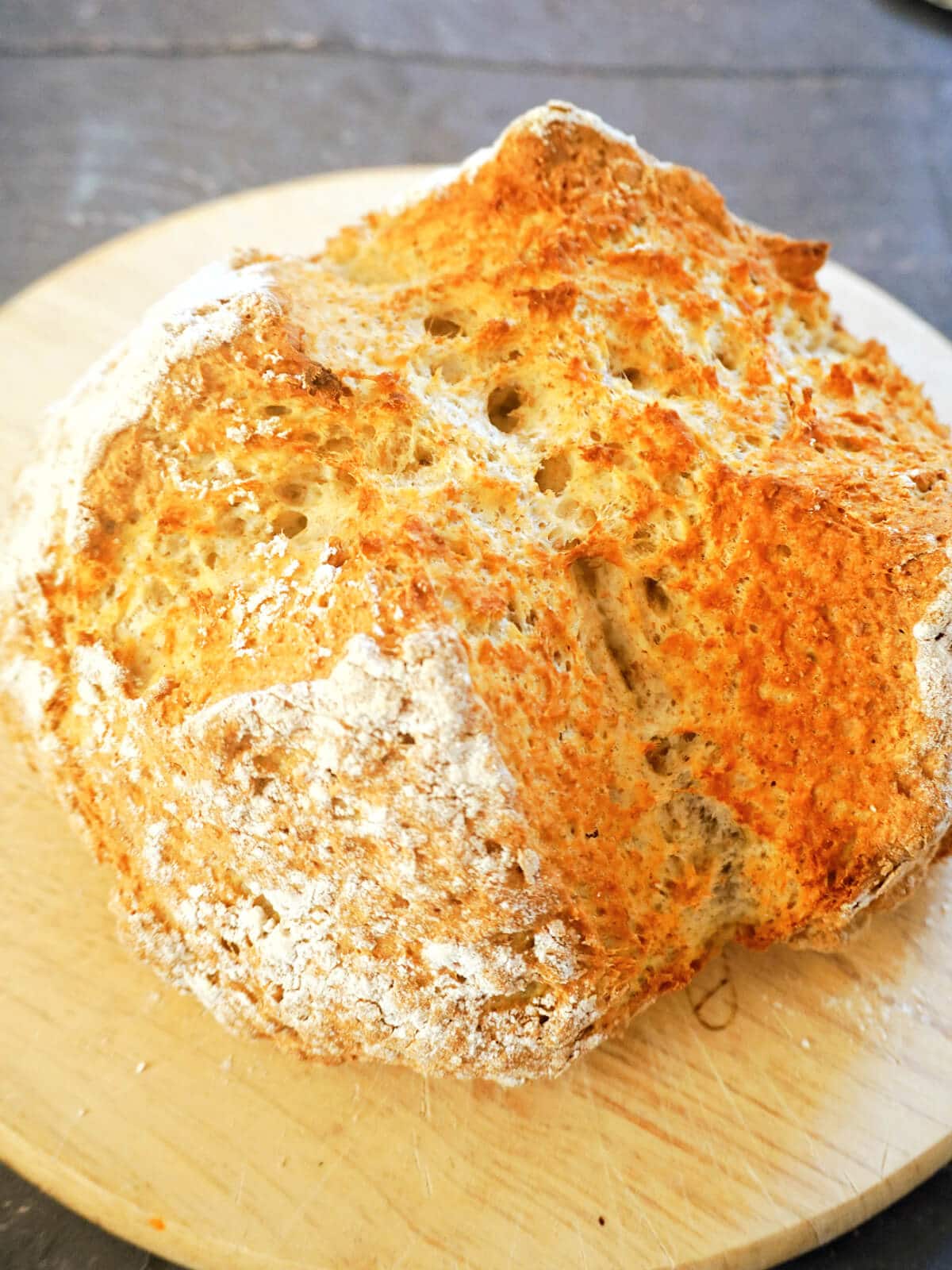 Close-up shot of a soda bread on a wooden board