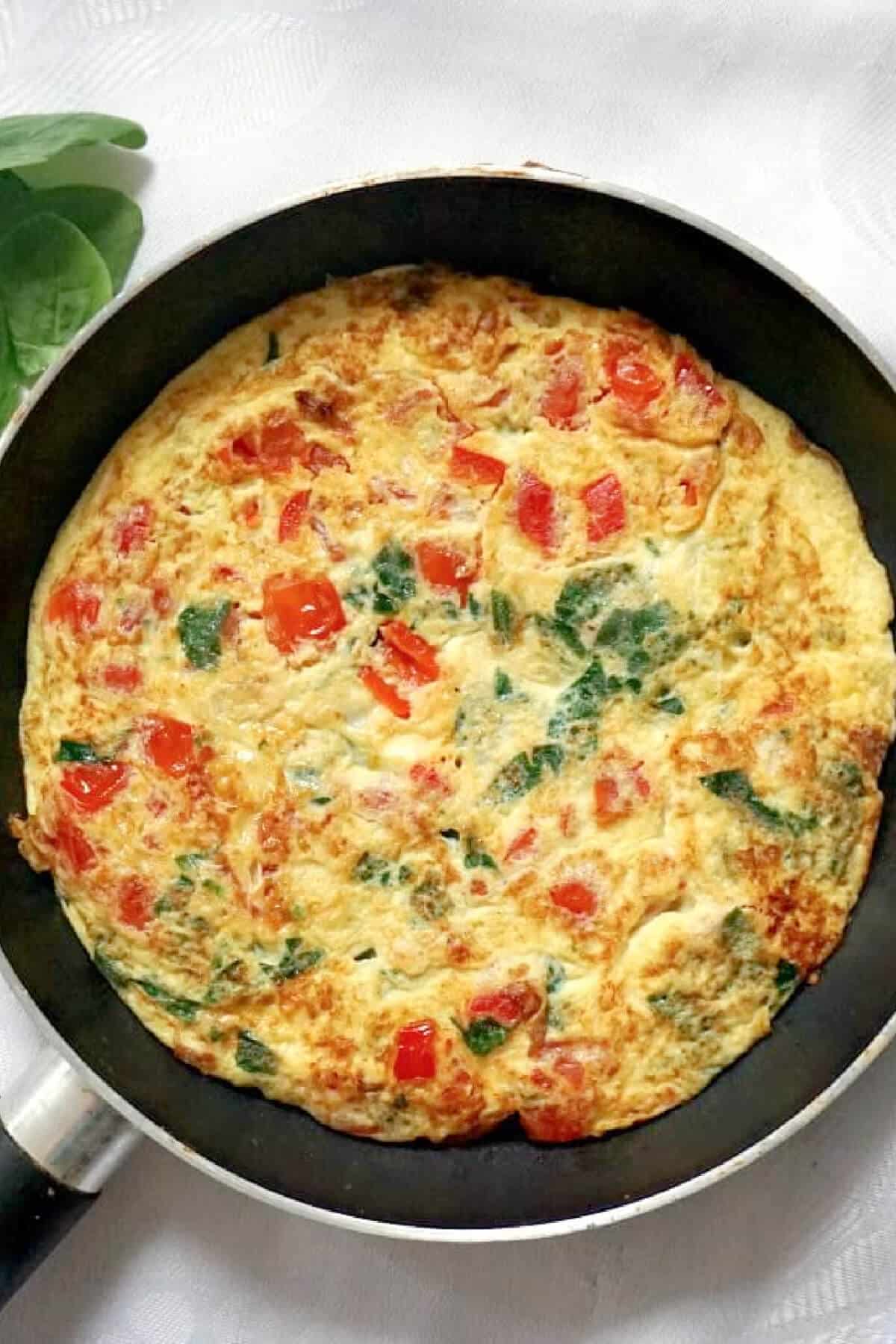 A frying pan with a vegetarian omelette