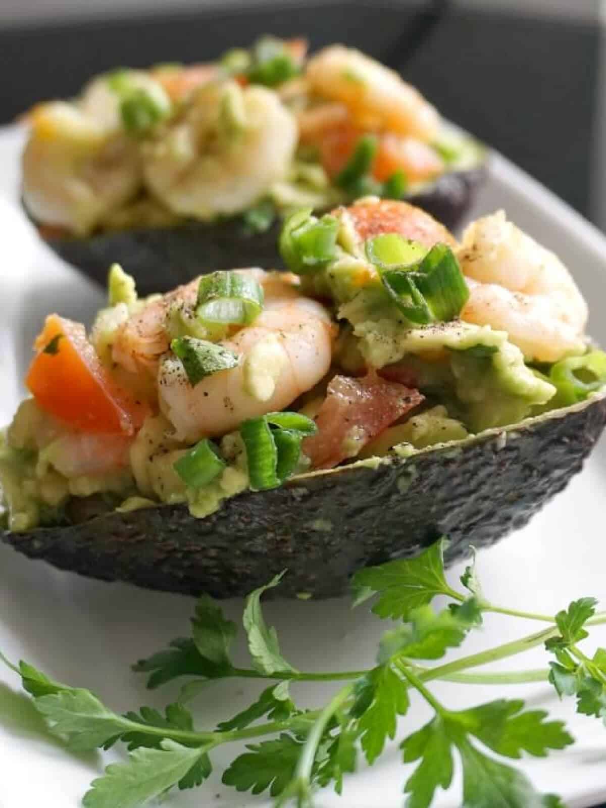 2 avocado skins topped with avocado prawn salad.