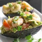 Healthy Avocado Shrimp Salad in avocado skins, a delicious and quick recipe with a lemon kick. If you are looking for lighter and more nutritious meals after all the heavy winter food, this is a recipe for you. Ready in just about 10 minutes., low carb, high protein, gluten free, keto-friendly. This salad is a great summer recipe, but also great all year around. Great on its own or as a side dish. Healthy, easy to make, and so delicious. #avocadoshrimpsalad, #salad, #prawns, #healthyfood