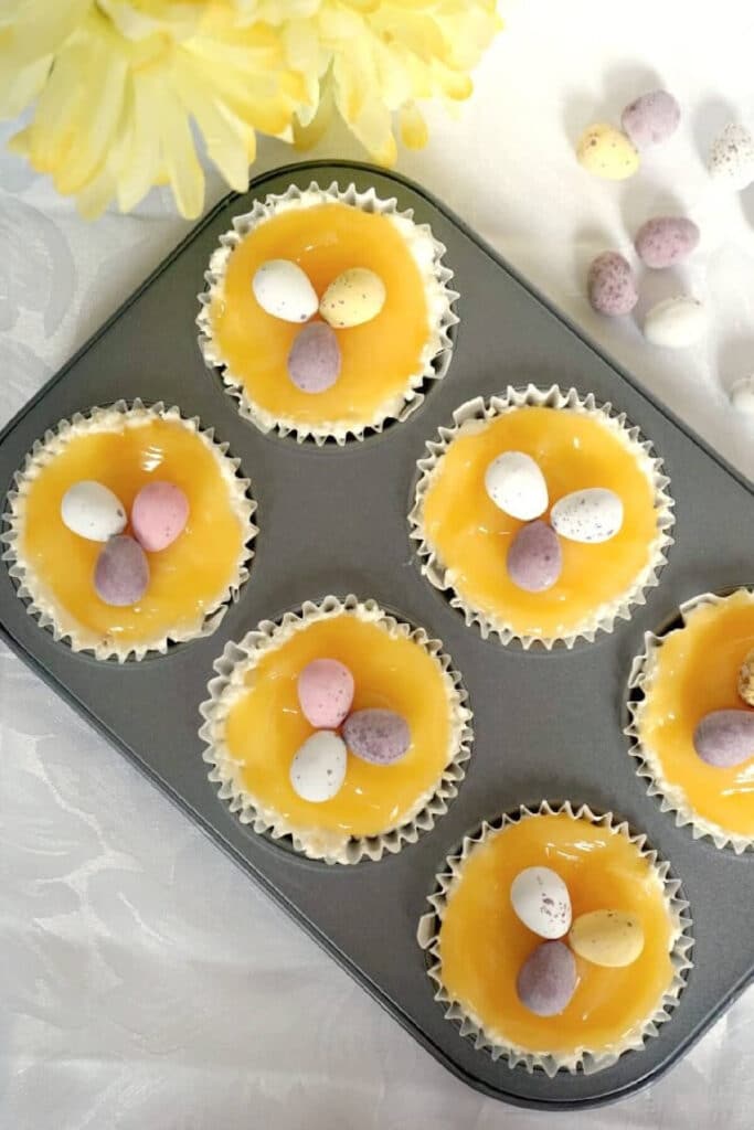 Overhead shoot of a mini  muffin tin with 6 lemon curd cheesecakes