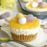 A mini lemon curd cheesecake on a white plate