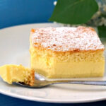 A slice of magic cake on a white plate