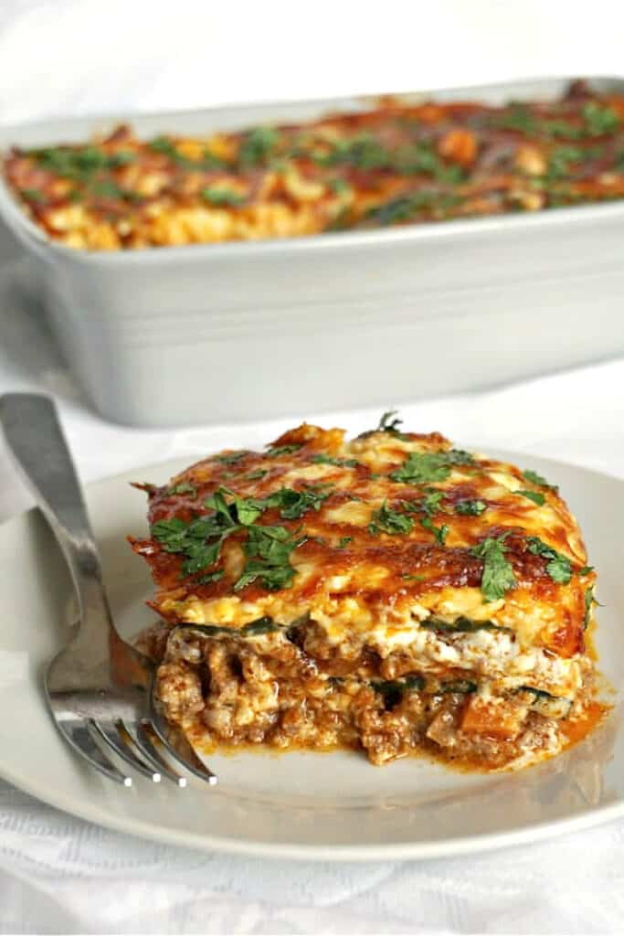 A slice of lasagna on a white plate