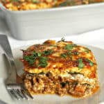 A slice of zucchini lasagna on a white plate
