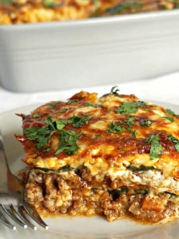 A slice of zucchini lasagna on a white plate