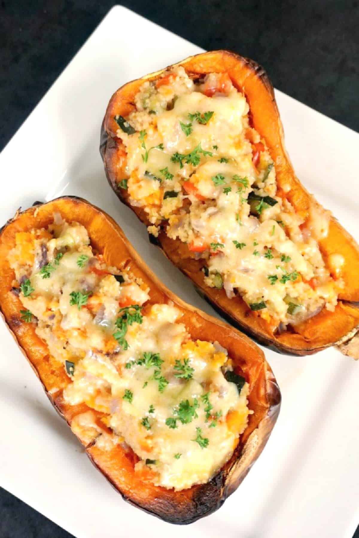 2 butternut squash halves stuffed with couscous.