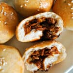 2 halves of pork buns with 4 whole buns around them.