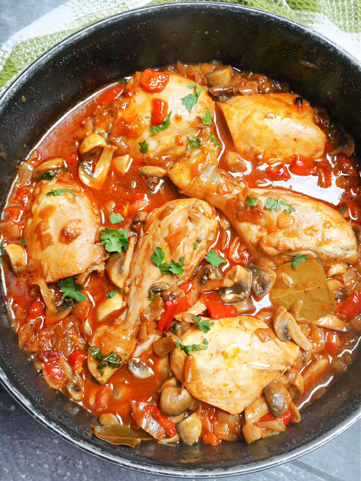 Overhead shoot of a pot with chicken and mushroom stew.