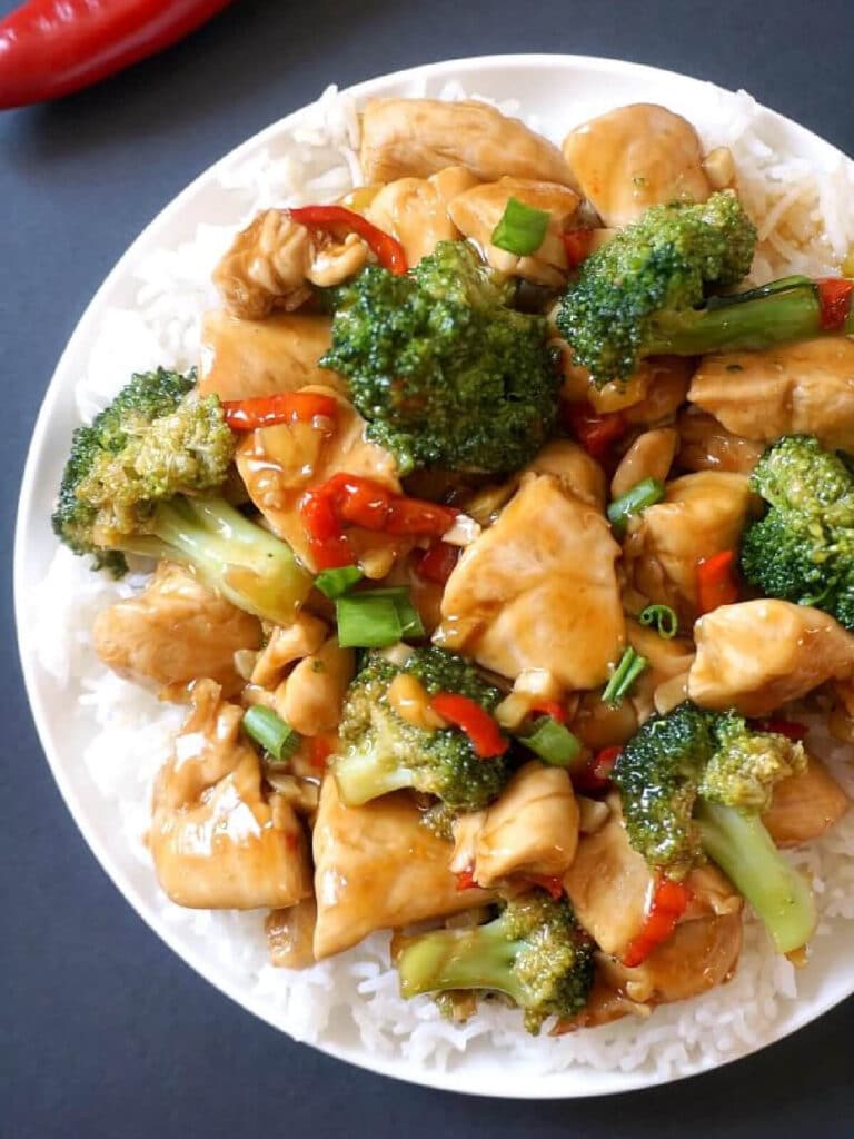 Overhead shoot of a white plate with rice and chicken and broccoli