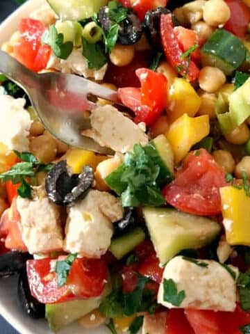 A white bowl with Mediterranean chickpea salad