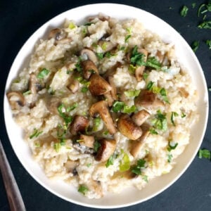 Overhead shoot of a white plate with mushroom risotto
