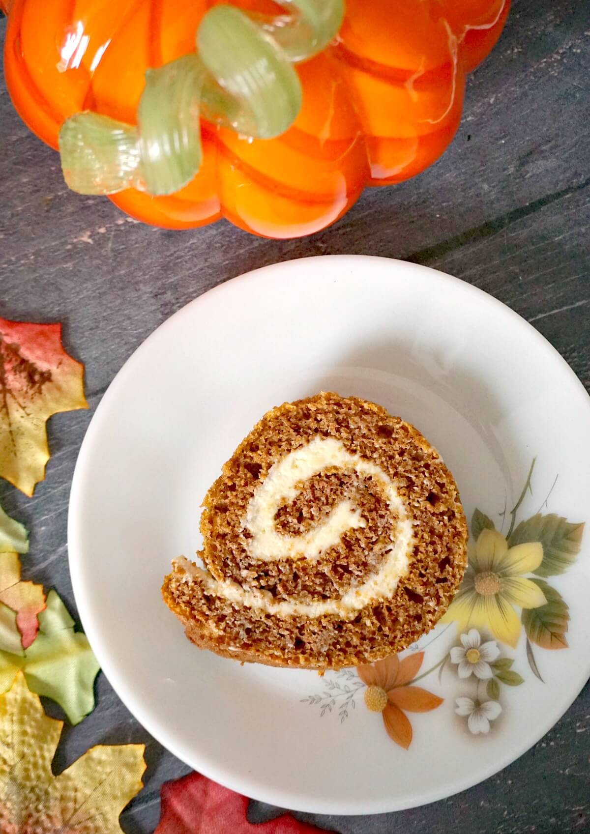 A slice of pumpkin roll on a plate.