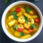 Overhead shot of a white bowl of coconut shrimp curry