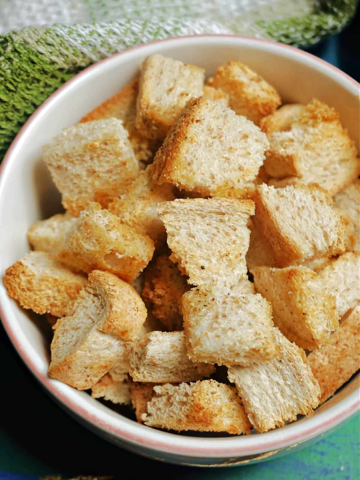 A white bowl with homemade croutons.
