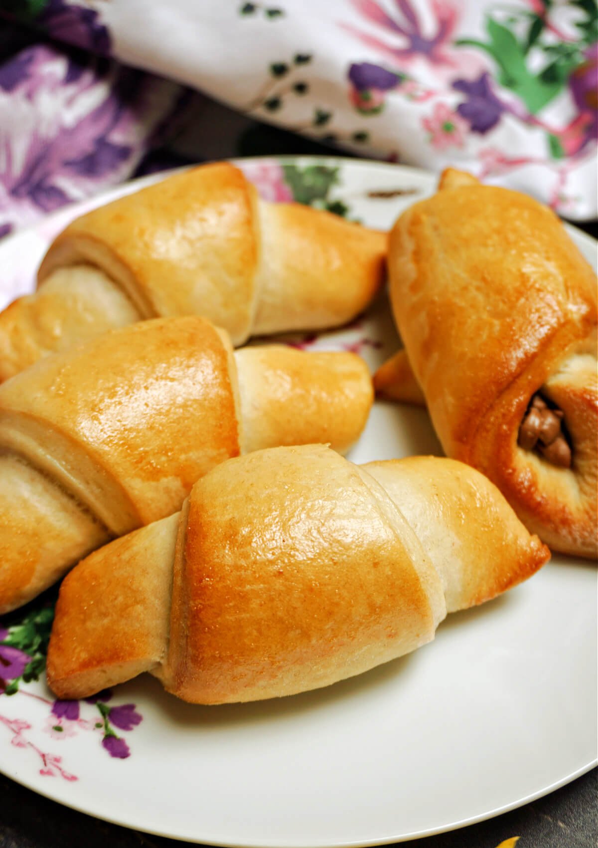 A plate with 4 crescent rolls.