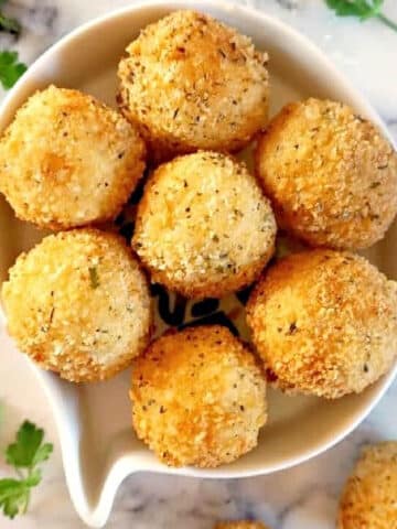 Overhead shoot of a white bowl with 7 mashed potato balls