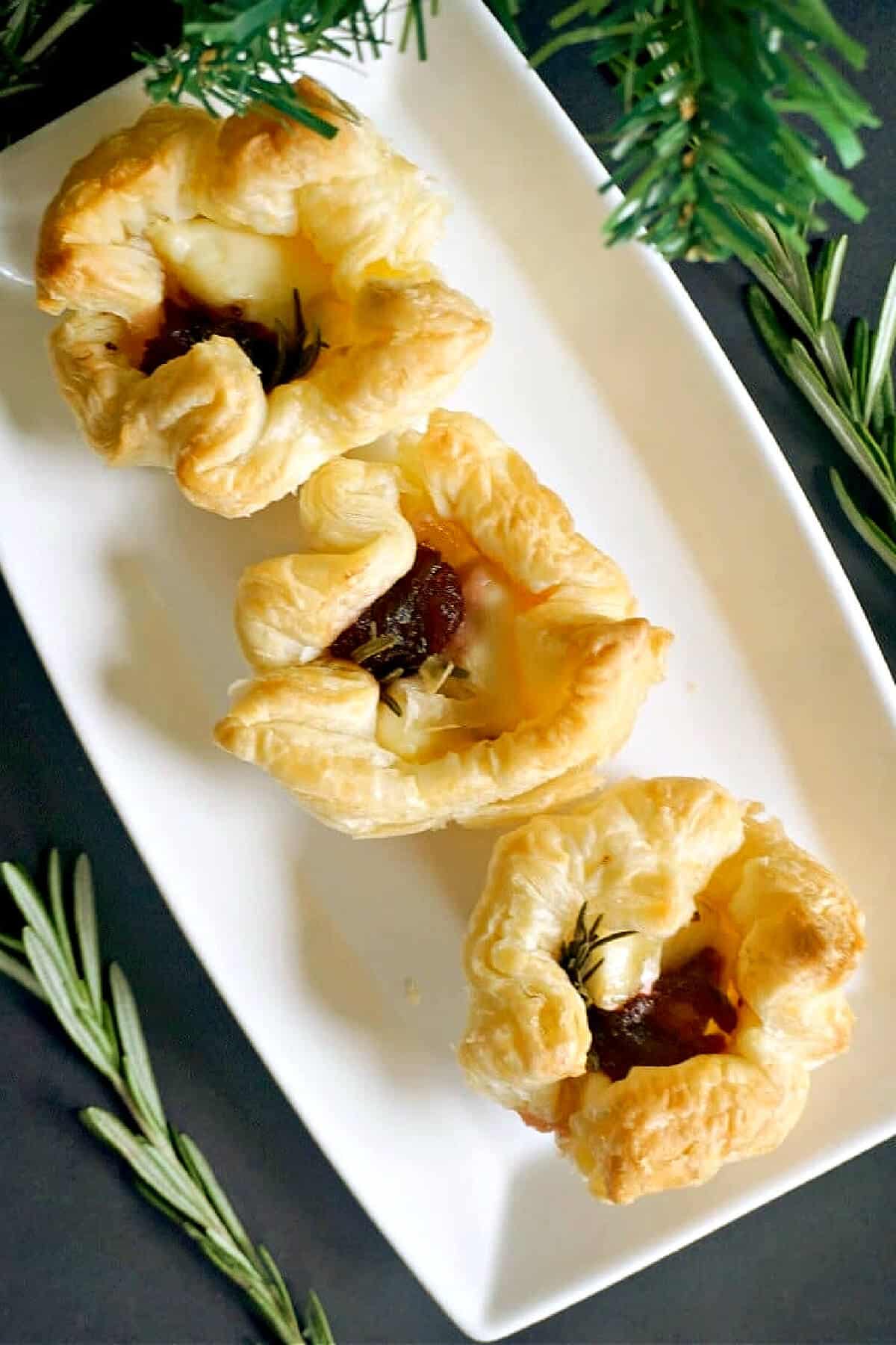 Overhead shoot of 3 brie and cranberry puff pastries.