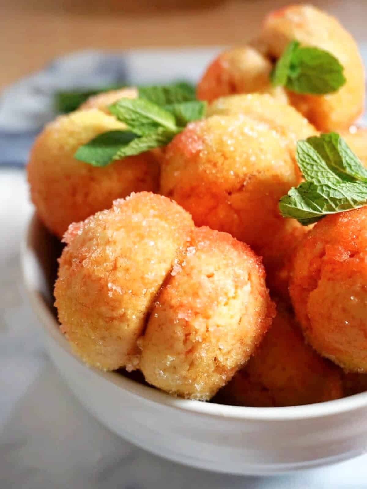 Close-up shoot of a white bowl with peach cookies.