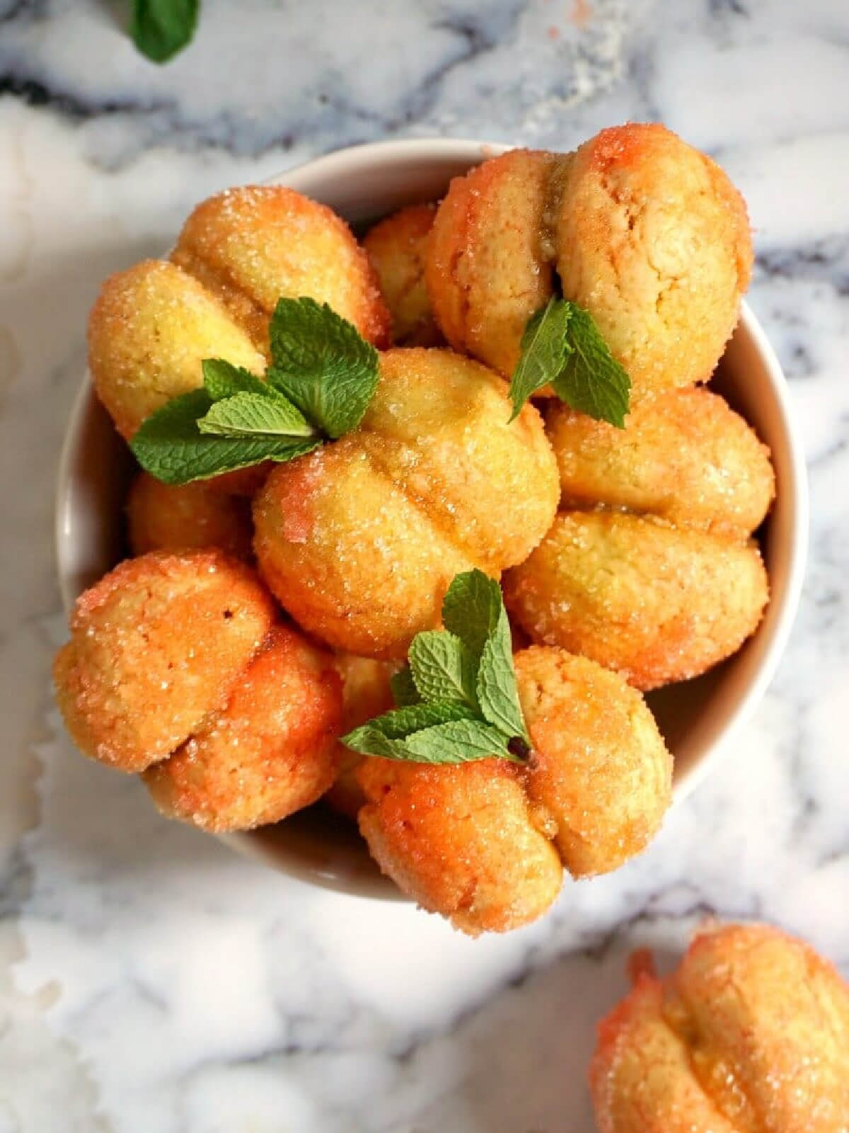 Overhead shoot of a white bowl with peach cookies.