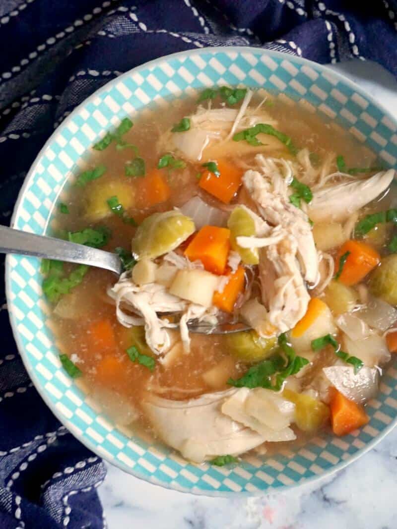 Overhead shoot of a blie bowl of slowe cooker chicken soup