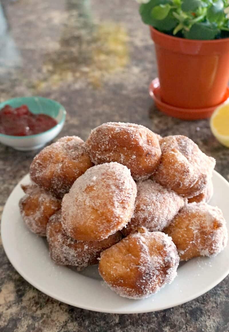 A white plate with beignets